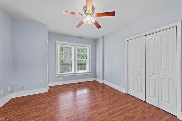 unfurnished bedroom featuring a closet, ceiling fan, and hardwood / wood-style floors