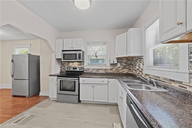 kitchen with white cabinetry and stainless steel appliances