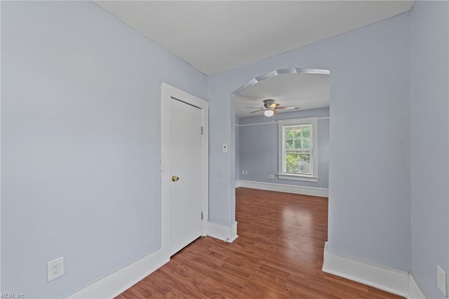 spare room with ceiling fan and wood-type flooring