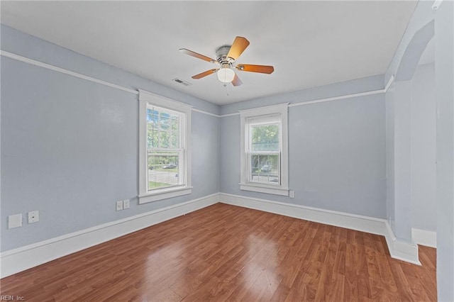 unfurnished room with ceiling fan and hardwood / wood-style flooring