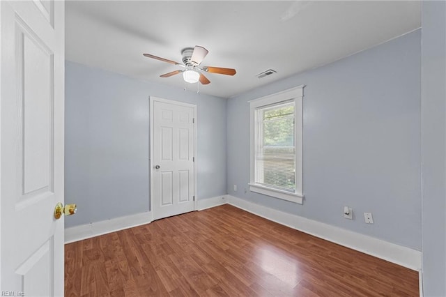 spare room featuring hardwood / wood-style flooring and ceiling fan