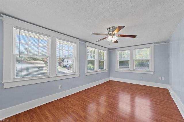 empty room featuring wood-type flooring, a textured ceiling, and ceiling fan