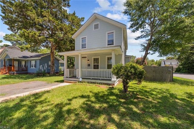 view of front of house featuring covered porch and a front lawn