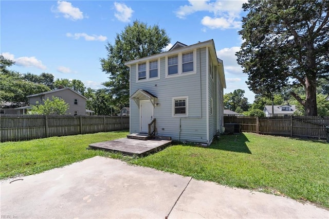 back of property with a patio area and a lawn