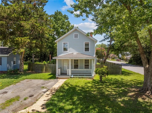 view of front of property with a porch and a front yard