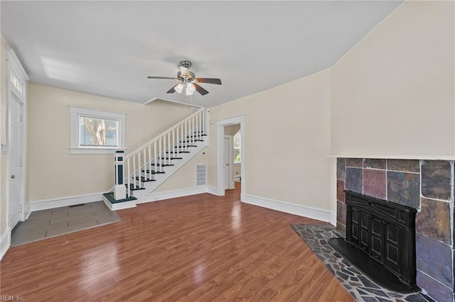 unfurnished living room featuring ceiling fan and wood-type flooring