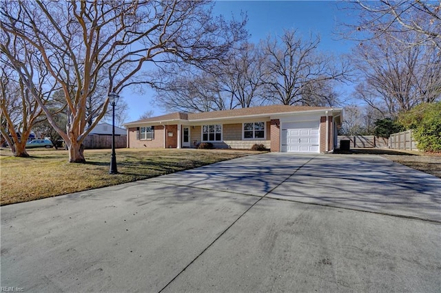 ranch-style home with a garage and a front lawn