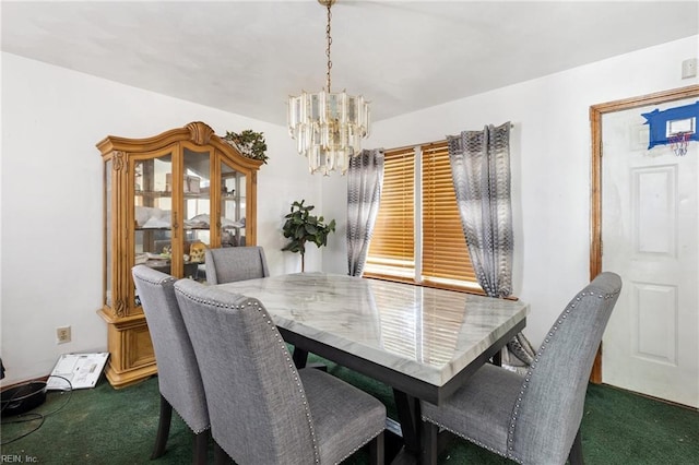 dining area featuring an inviting chandelier and dark colored carpet