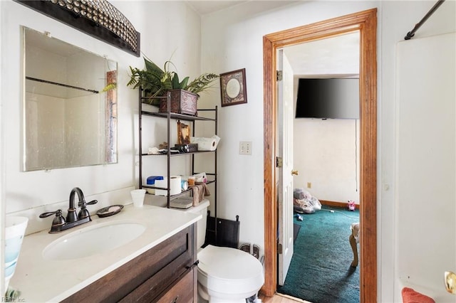 bathroom with a shower, vanity, and toilet