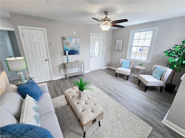 living room with ceiling fan and dark wood-type flooring