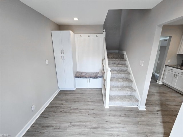 staircase featuring wood-type flooring