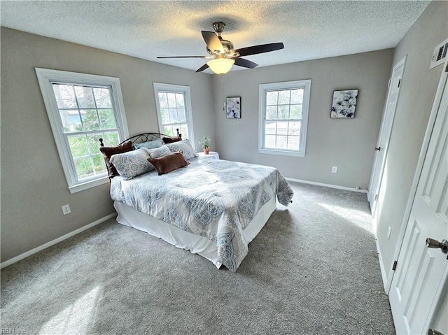 bedroom featuring ceiling fan, a textured ceiling, and carpet floors