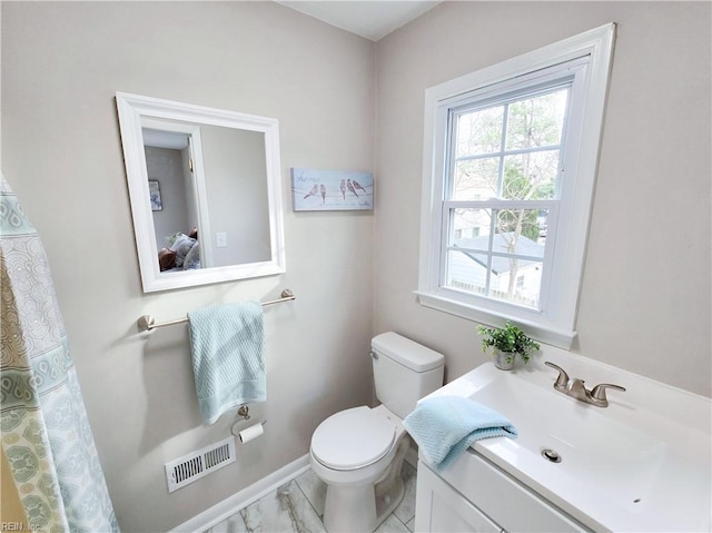 bathroom featuring toilet and vanity