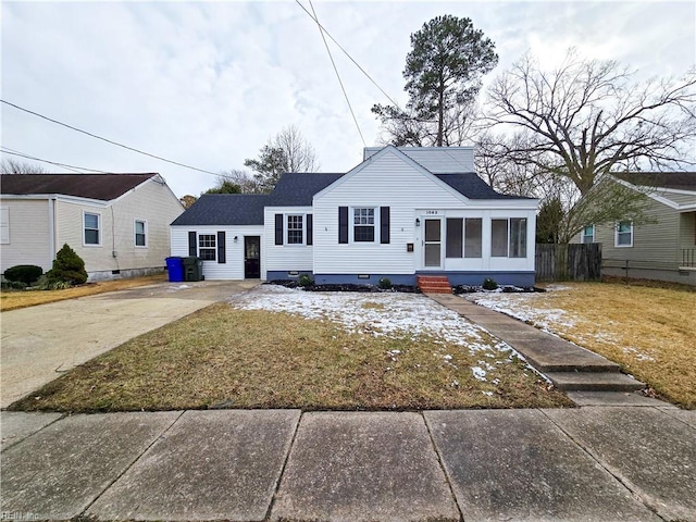 view of front of home featuring a front yard and a sunroom