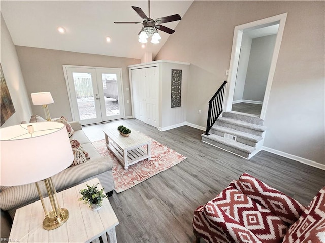 living room with high vaulted ceiling, dark hardwood / wood-style floors, french doors, and ceiling fan