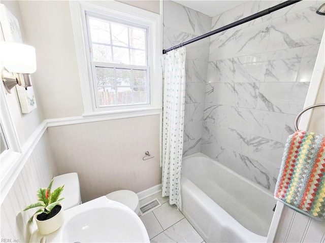 bathroom with toilet and shower / tub combo with curtain