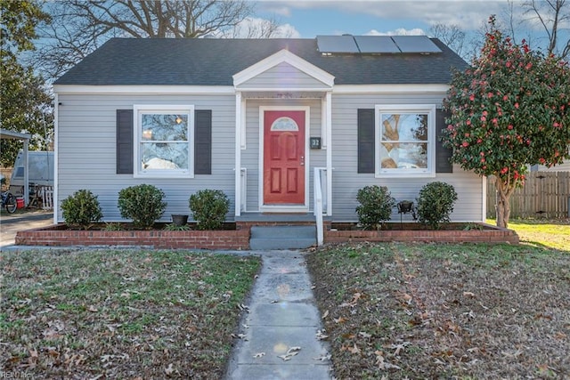 bungalow-style house with a front lawn