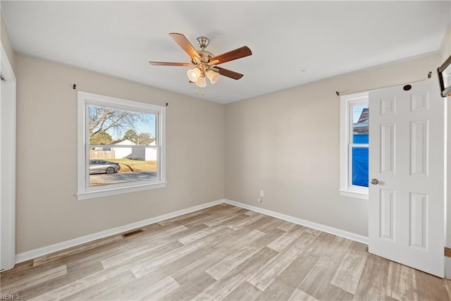 unfurnished room with light wood-type flooring and ceiling fan