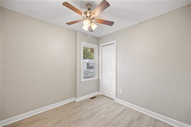 empty room featuring ceiling fan and light hardwood / wood-style flooring