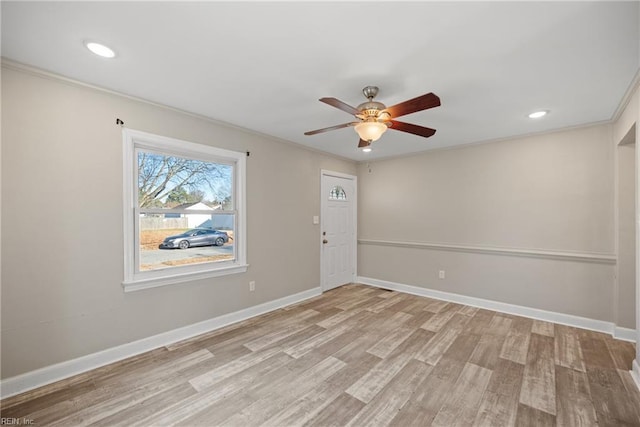 empty room with light hardwood / wood-style flooring, ceiling fan, and ornamental molding