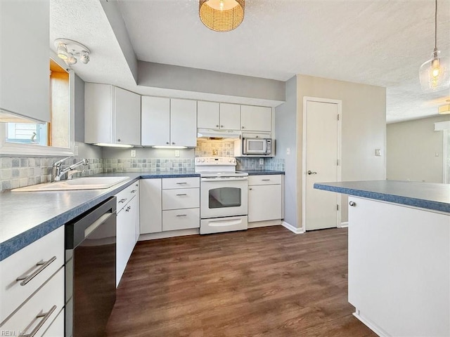 kitchen with white appliances, dark wood-type flooring, sink, white cabinetry, and decorative light fixtures