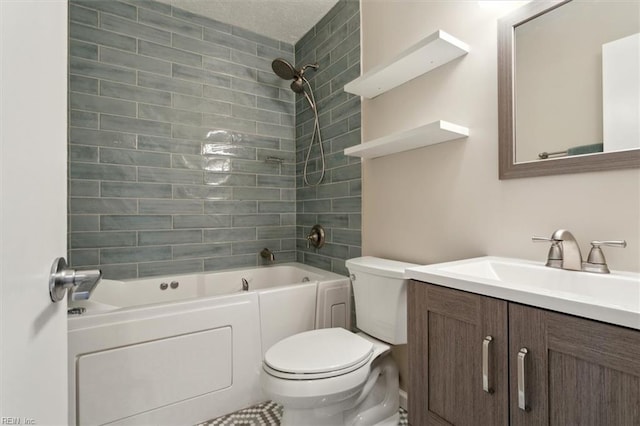 full bathroom featuring toilet, tiled shower / bath, and vanity