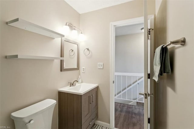 bathroom featuring toilet and vanity