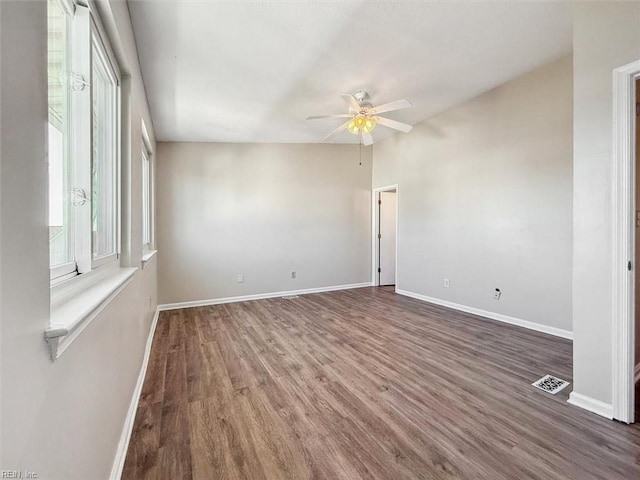 spare room with ceiling fan and dark hardwood / wood-style floors