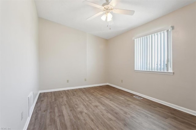 unfurnished room with ceiling fan and hardwood / wood-style flooring