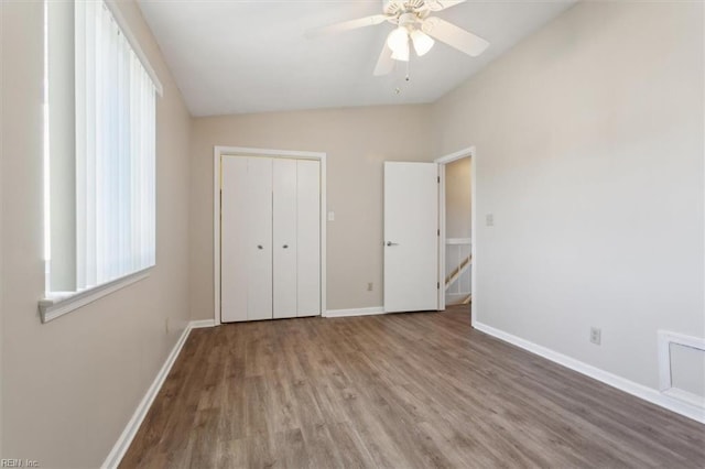 unfurnished bedroom featuring ceiling fan, hardwood / wood-style floors, and a closet