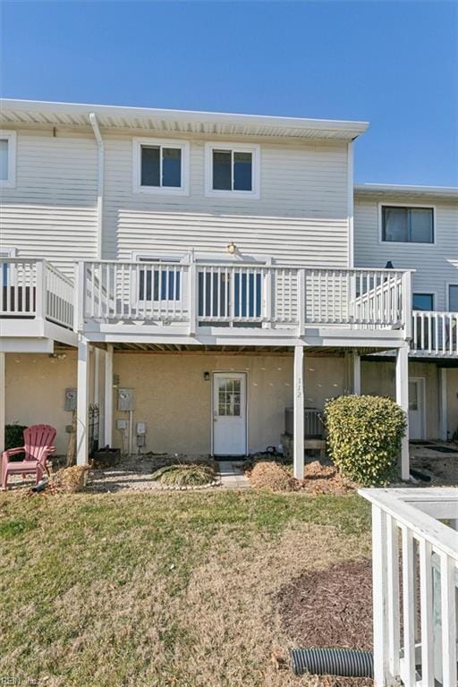 rear view of property featuring central AC, a deck, and a lawn