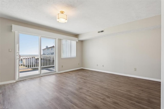 unfurnished room featuring dark hardwood / wood-style floors