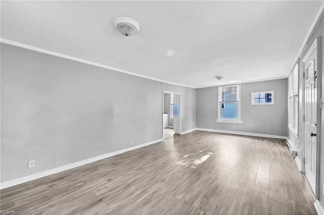 unfurnished room with hardwood / wood-style floors and crown molding