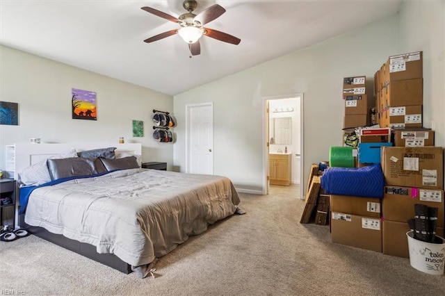 carpeted bedroom featuring connected bathroom, vaulted ceiling, and ceiling fan