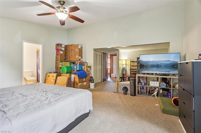 bedroom featuring ceiling fan and ensuite bath