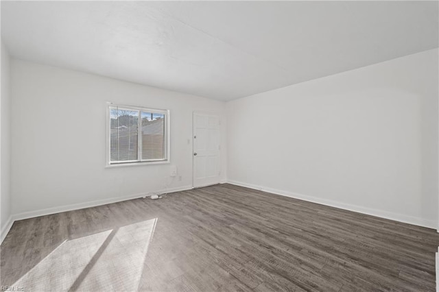 spare room featuring dark hardwood / wood-style floors