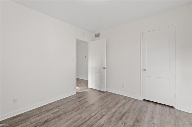 spare room featuring light hardwood / wood-style floors