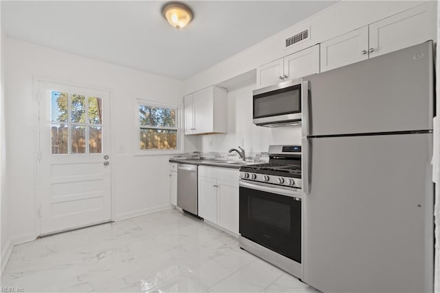 kitchen featuring white cabinetry and appliances with stainless steel finishes