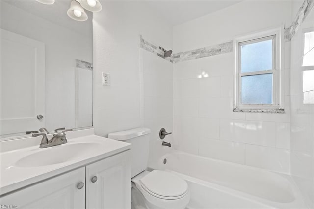 full bathroom featuring toilet, vanity, and tiled shower / bath