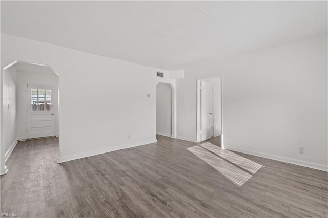 spare room with dark hardwood / wood-style flooring