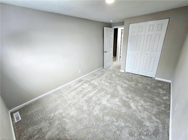 unfurnished bedroom with carpet flooring and a closet