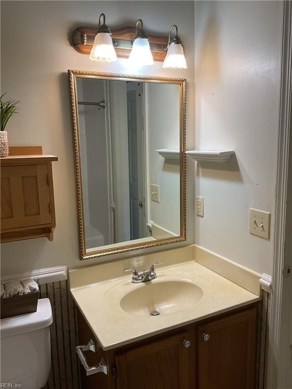 bathroom with toilet and vanity