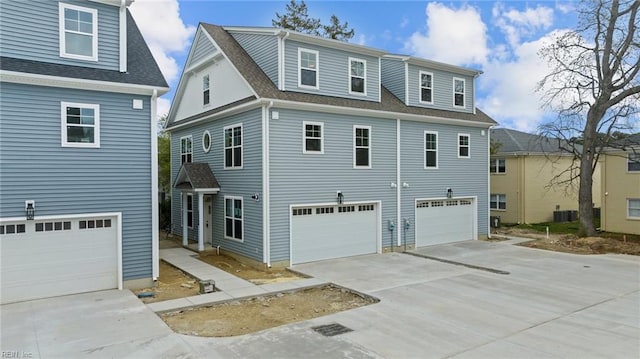 view of front facade featuring a garage and central AC unit