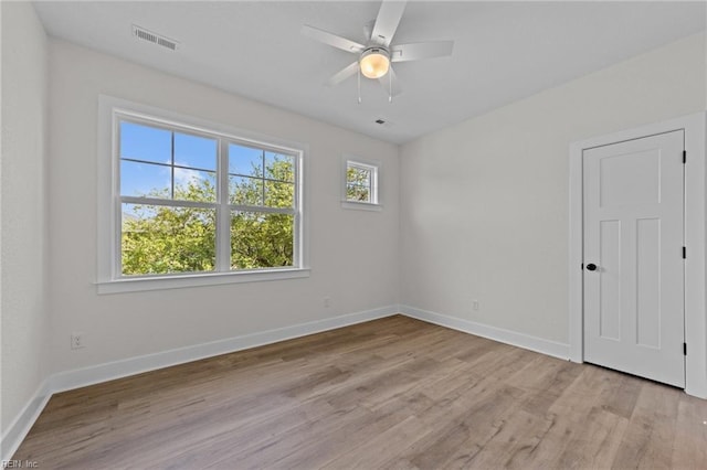 empty room featuring ceiling fan and light hardwood / wood-style flooring