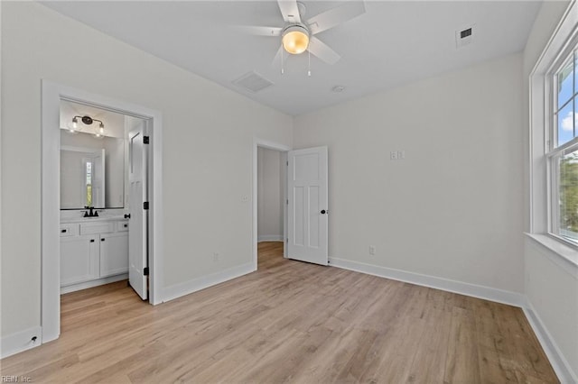 unfurnished bedroom featuring ceiling fan, light hardwood / wood-style floors, and ensuite bathroom