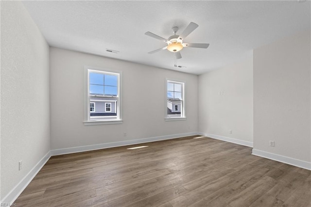 unfurnished room featuring ceiling fan and dark hardwood / wood-style floors