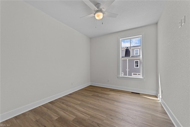 unfurnished room featuring ceiling fan and light hardwood / wood-style floors