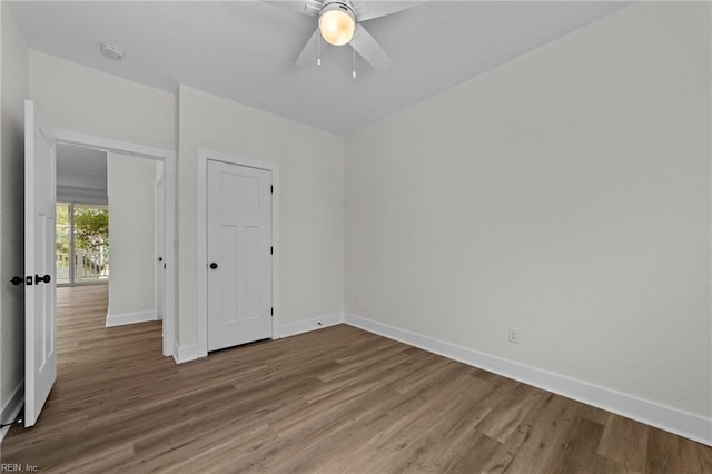 empty room with ceiling fan and hardwood / wood-style floors