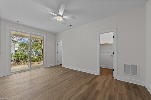 spare room with ceiling fan and hardwood / wood-style flooring