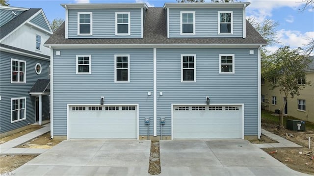 view of front of house with cooling unit and a garage